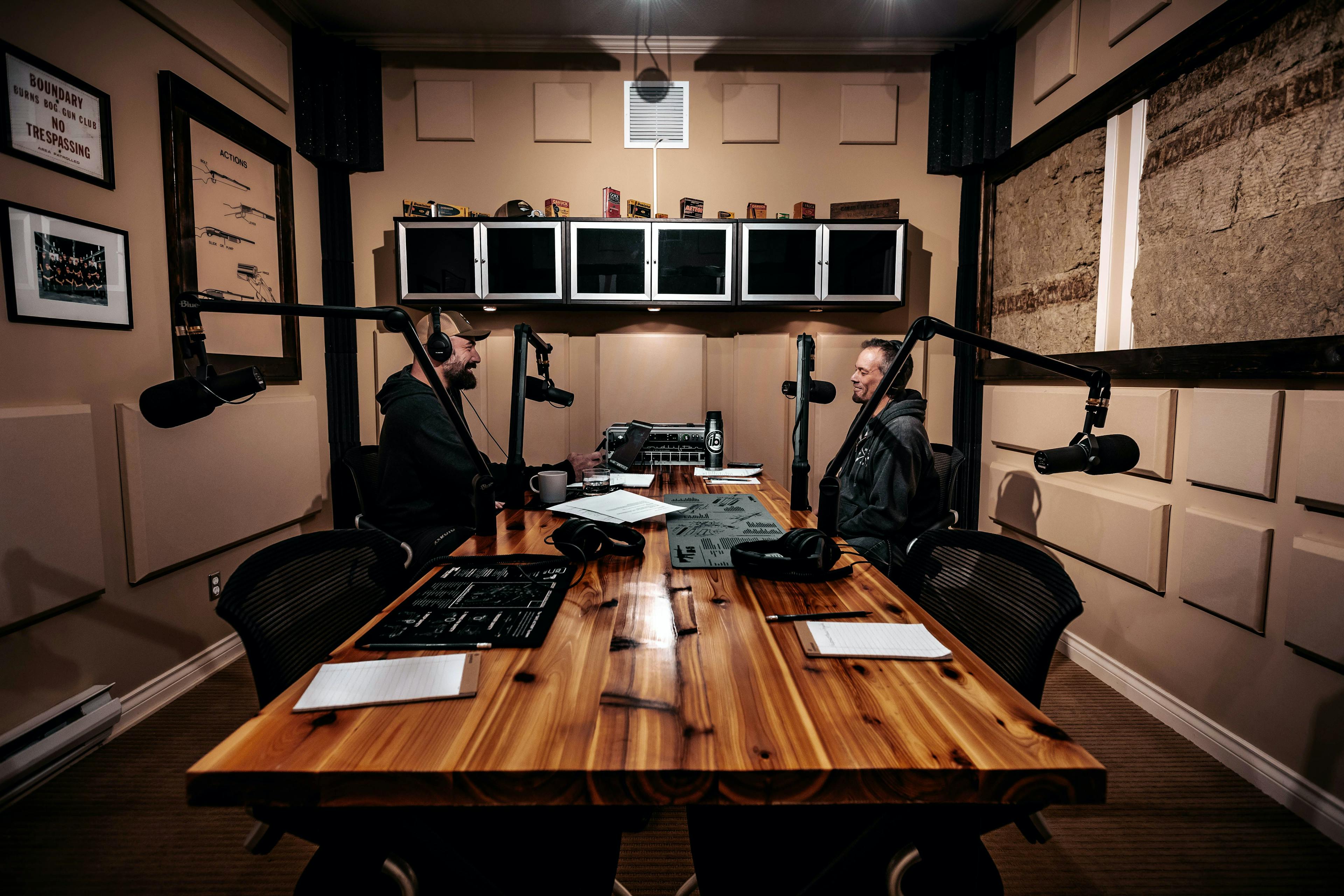 Two people sitting in a podcast studio