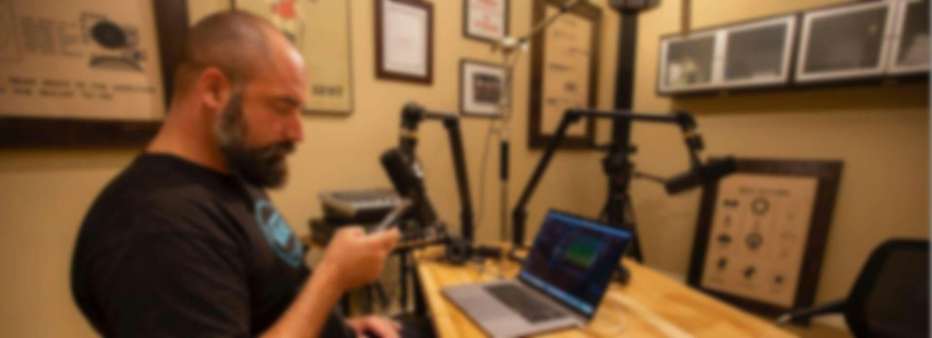 A blurred image of someone recording a podcast
