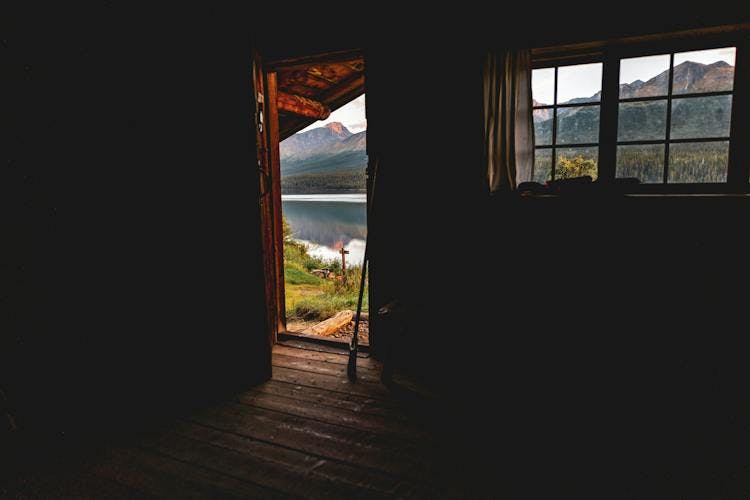 A view of a door and window from inside a cabin