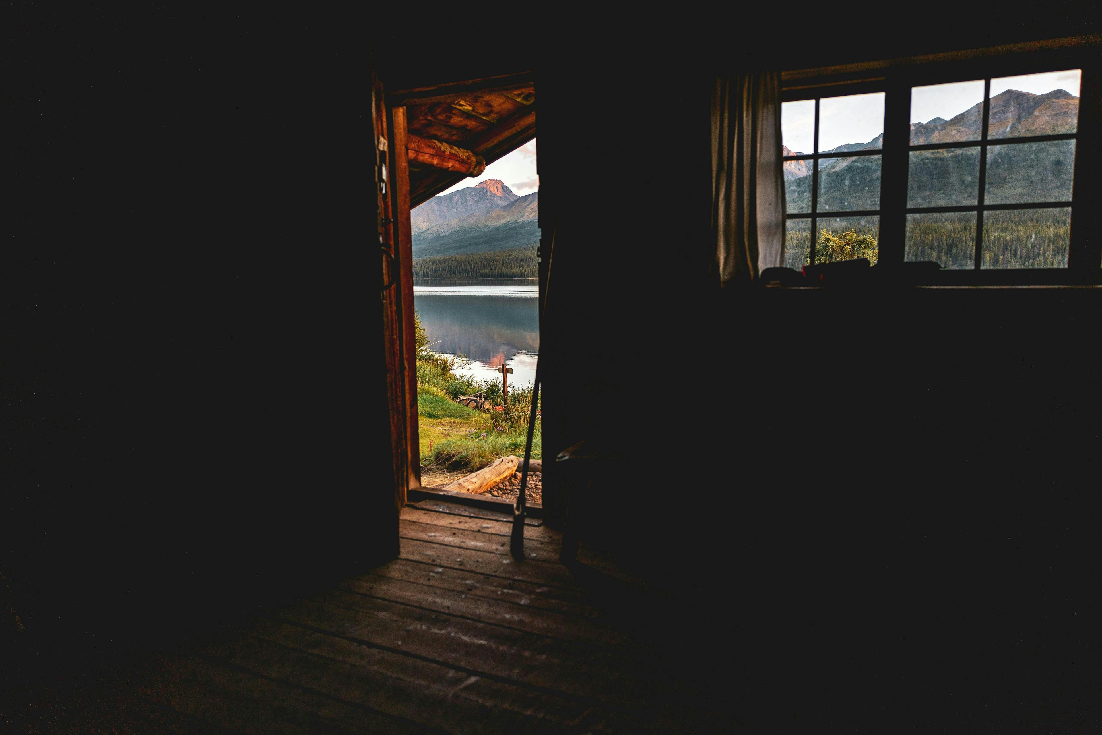 A view of a door and window from inside a cabin