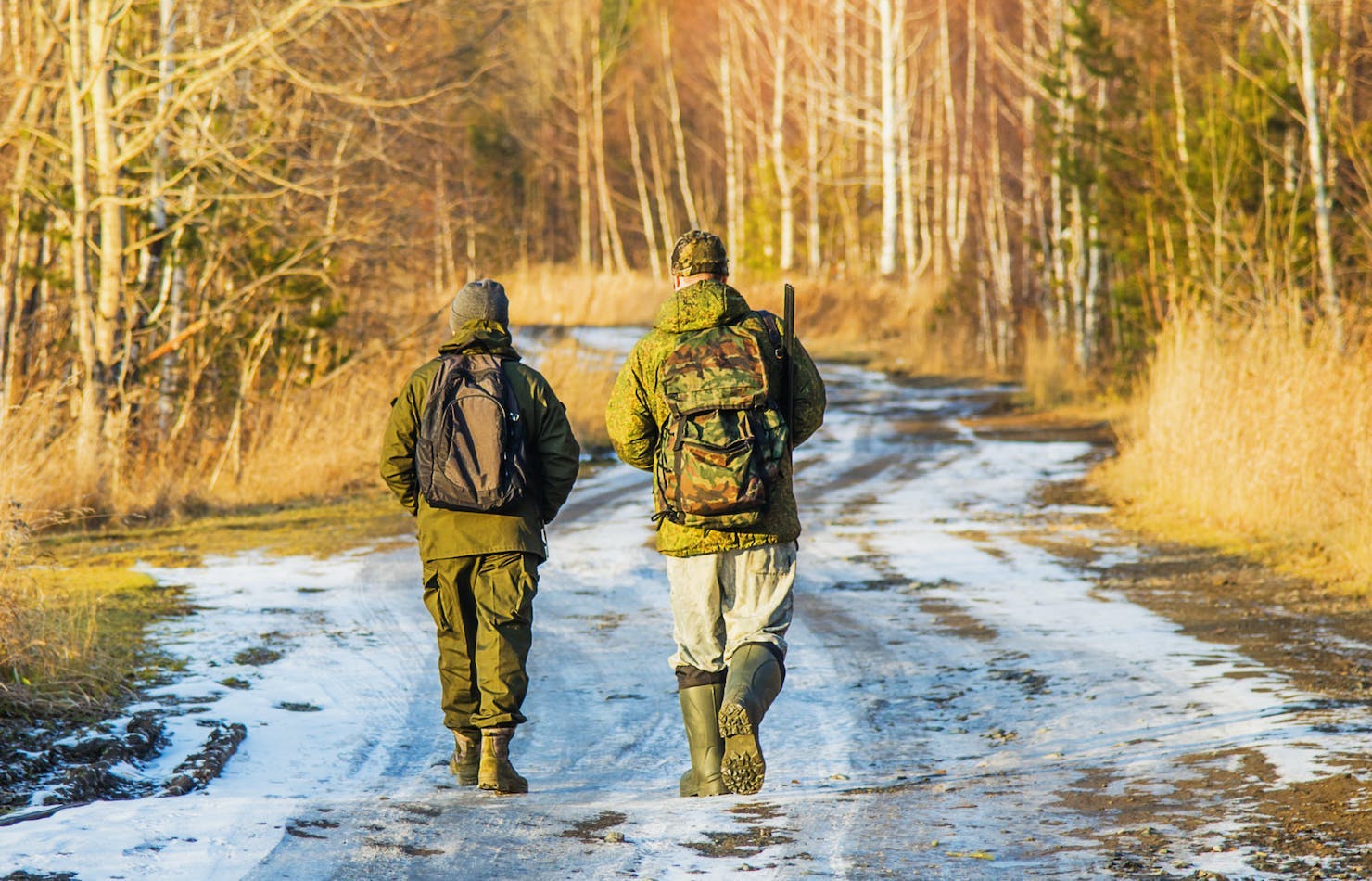 Two hunters winter trail
