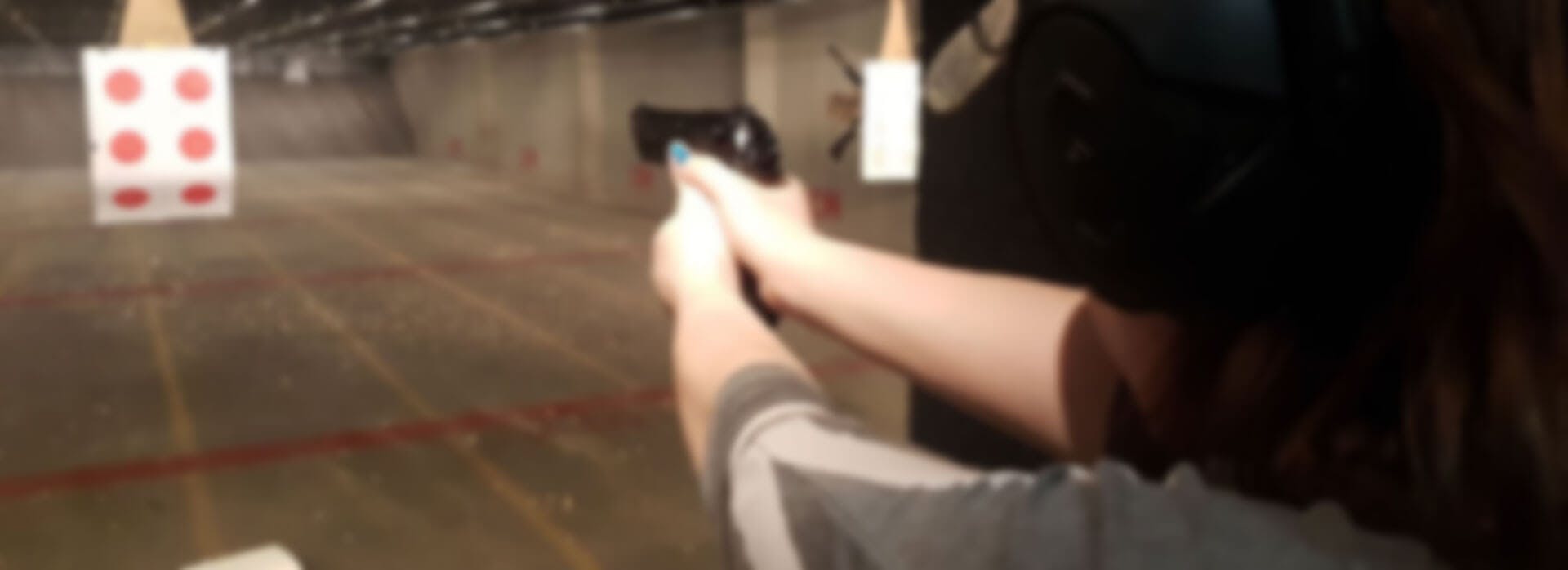 A person aiming a gun at a tartget